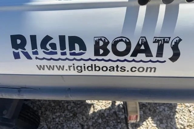 Slide: The Image of Rigid Boats 10 Sport 2024 logo with website URL on boat exterior. - 16