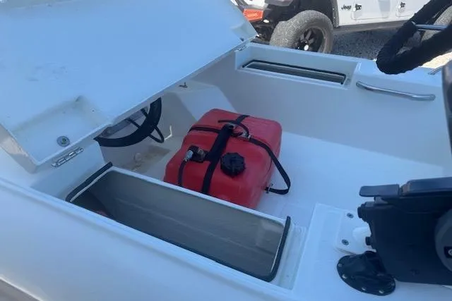 Slide: The Image of 2024 Rigid Boats 10 Sport interior with open storage and red fuel tank. - 6