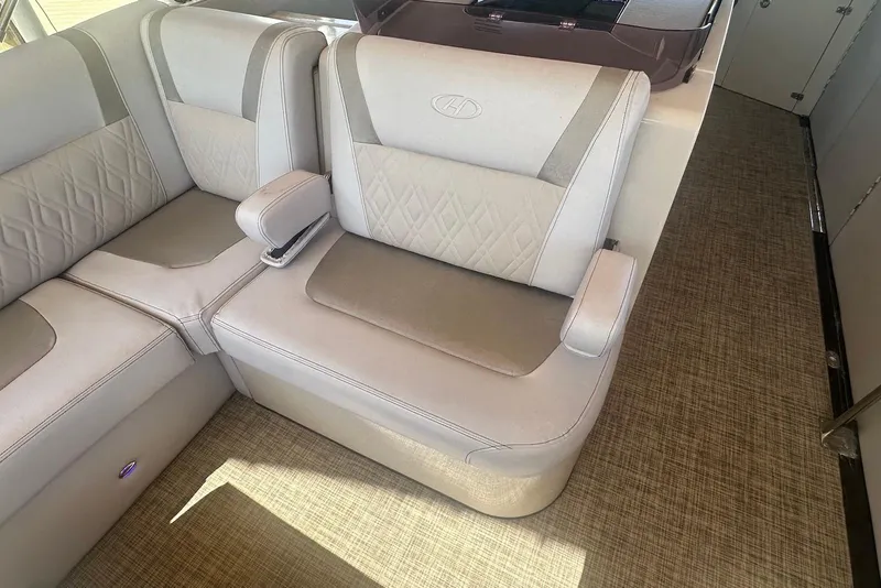 Slide: The Image of Luxurious seating in a 2017 Harris V270 boat, featuring elegant upholstery and armrests. - 10