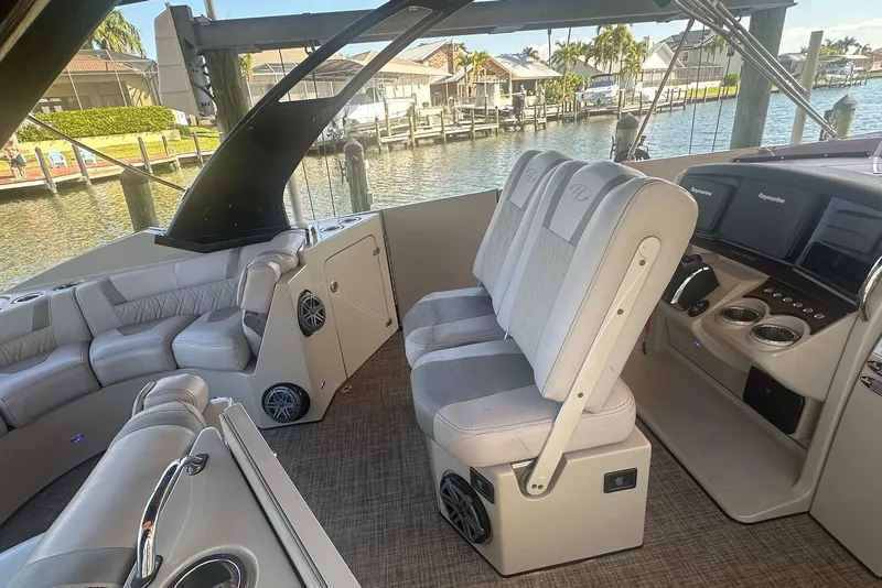 Slide: The Image of Interior of a 2017 Harris V270 boat with plush seating and modern controls. - 12