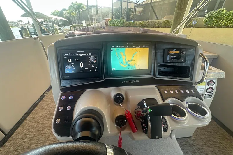 Slide: The Image of 2017 Harris V270 boat dashboard with navigation screens and controls. - 13