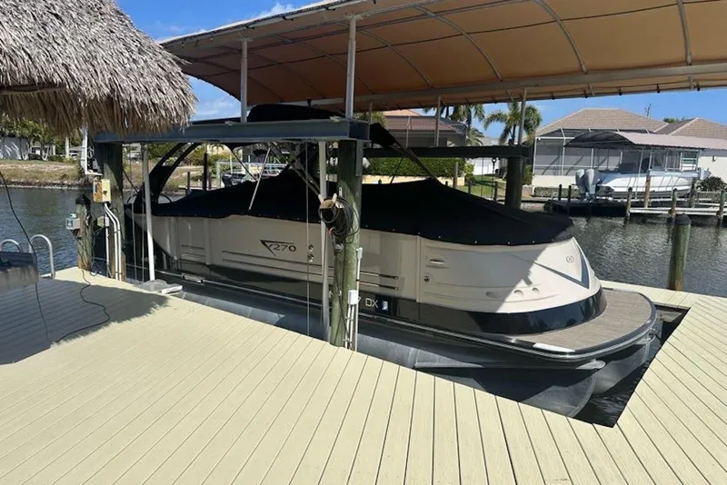 Slide: The Image of 2017 Harris V270 boat docked under a canopy on a sunny day. - 18