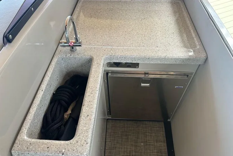 Slide: The Image of 2017 Harris V270 boat kitchenette with sink, faucet, and storage compartment. - 22