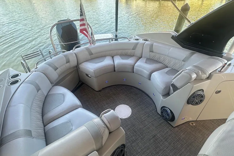 Slide: The Image of Luxurious seating area on a 2017 Harris V270 boat with American flag. - 8