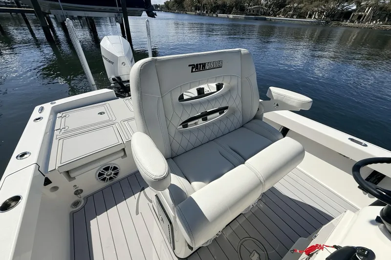Slide: The Image of 2023 Pathfinder 2600 TRS boat interior with luxurious seating and water view. - 11