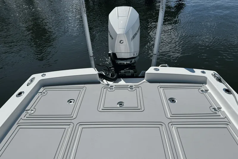 Slide: The Image of 2023 Pathfinder 2600 TRS boat deck with Mercury outboard motor on water. - 16