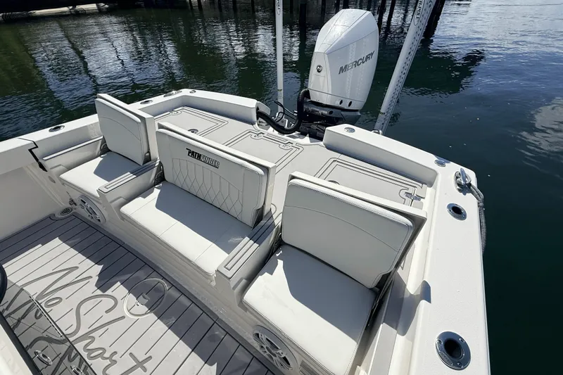 Slide: The Image of 2023 Pathfinder 2600 TRS boat interior with seating and Mercury engine. - 19