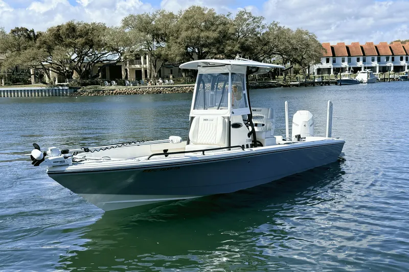 Slide: The Image of 2023 Pathfinder 2600 TRS boat on calm water, with scenic waterfront background. - 3
