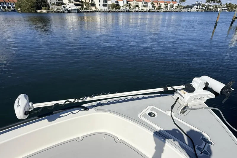 Slide: The Image of 2023 Pathfinder 2600 TRS boat with Minn Kota trolling motor on calm water. - 4
