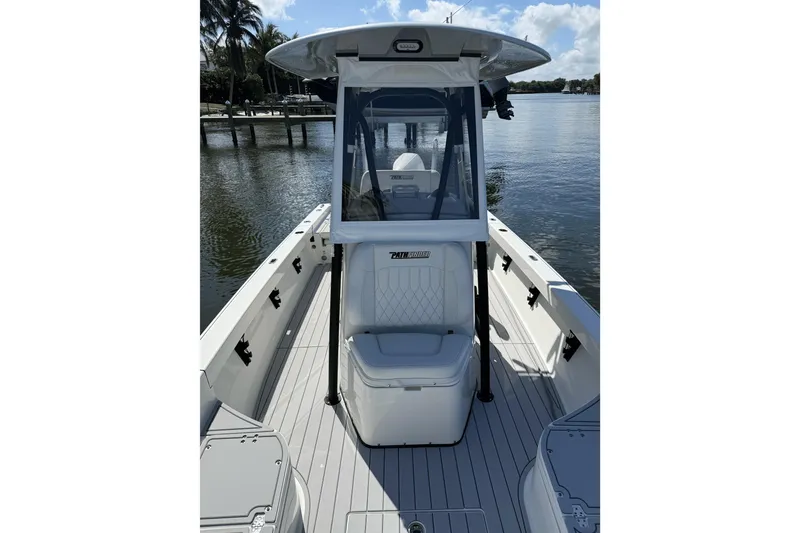 Slide: The Image of 2023 Pathfinder 2600 TRS boat on calm water, featuring sleek design and spacious deck. - 7