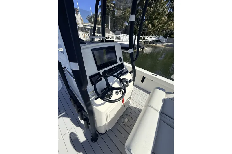 Slide: The Image of 2023 Pathfinder 2600 TRS boat console with steering wheel and navigation display. - 8