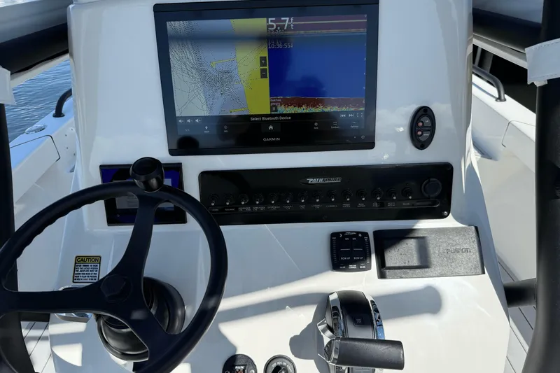 Slide: The Image of 2023 Pathfinder 2600 TRS boat dashboard with Garmin display and steering wheel. - 9
