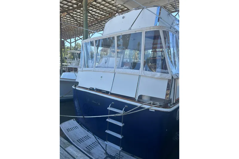 Slide: The Image of 1978 Chris-Craft 45 Commander yacht docked under a covered marina. - 16