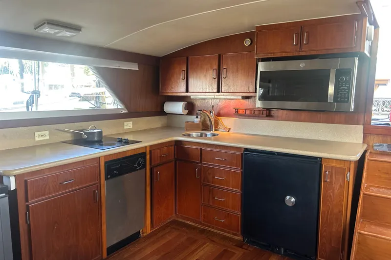 Slide: The Image of 1978 Chris-Craft 45 Commander yacht kitchen with wood cabinets and modern appliances. - 18