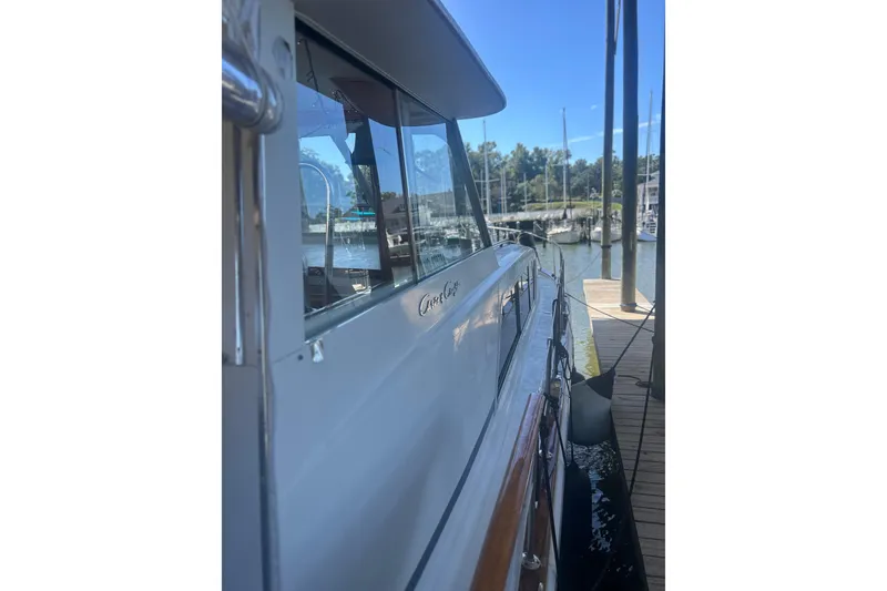 Slide: The Image of 1978 Chris-Craft 45 Commander yacht docked at marina, side view. - 3