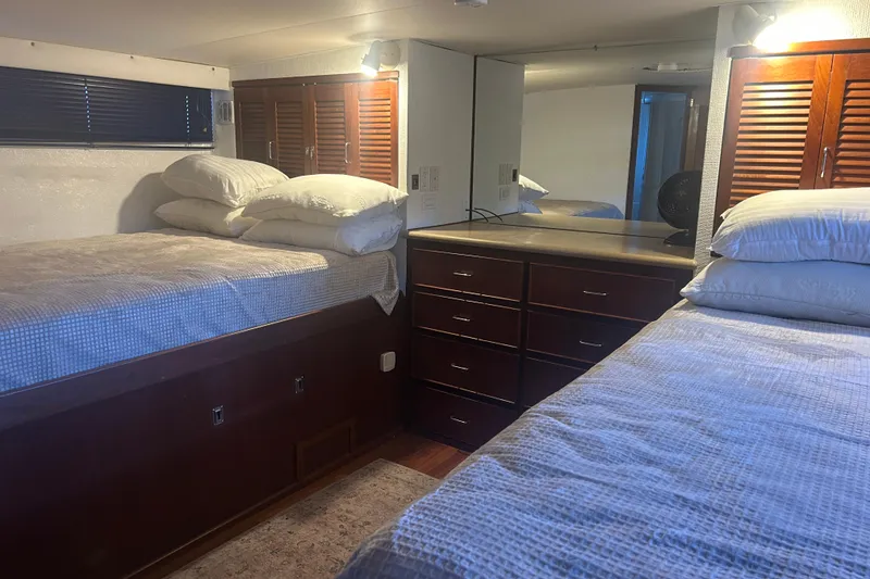 Slide: The Image of Interior of 1978 Chris-Craft 45 Commander yacht with twin beds and wooden cabinetry. - 34