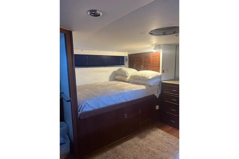 Slide: The Image of Cozy bedroom interior of 1978 Chris-Craft 45 Commander yacht with bed and wooden cabinets. - 35