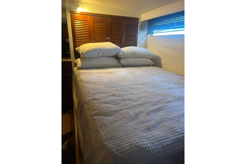 Slide: The Image of Cozy bedroom interior of 1978 Chris-Craft 45 Commander yacht with wooden cabinets. - 37