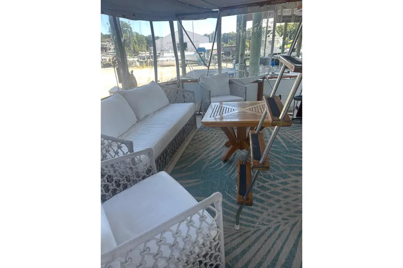 Slide: The Image of Luxurious interior of 1978 Chris-Craft 45 Commander yacht with elegant seating and wooden table. - 39