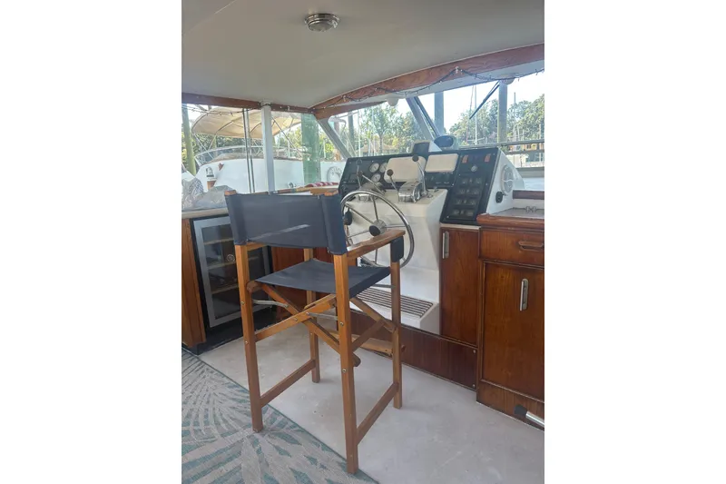 Slide: The Image of 1978 Chris-Craft 45 Commander helm with wooden chair and control panel. - 42