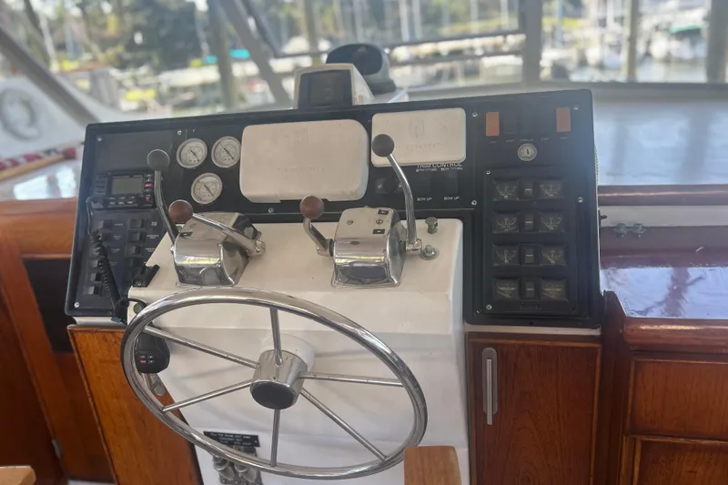 Slide: The Image of 1978 Chris-Craft 45 Commander helm with steering wheel and control panel. - 43