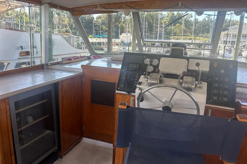 Slide: The Image of 1978 Chris-Craft 45 Commander helm with wooden cabinetry and marina view. - 45