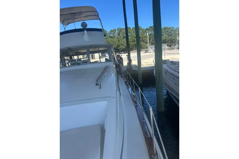 Slide: The Image of 1978 Chris-Craft 45 Commander yacht docked, side view with clear blue sky. - 6