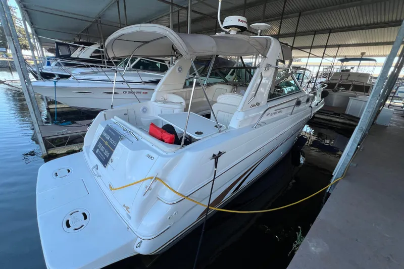 Slide: The Image of 1999 Sea Ray 290 Sundancer docked in a covered marina. - 4