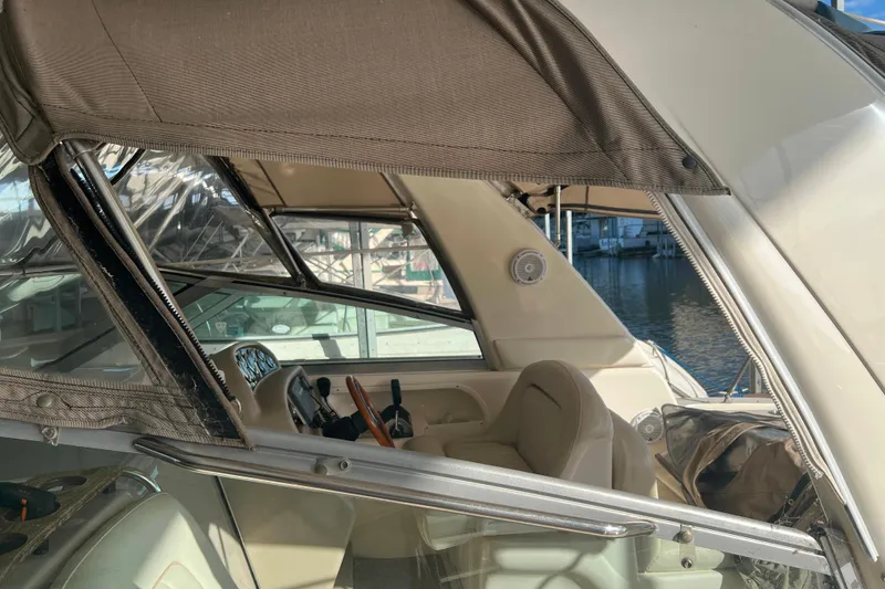 Slide: The Image of 1999 Sea Ray 290 Sundancer boat interior with steering wheel and seating. - 6