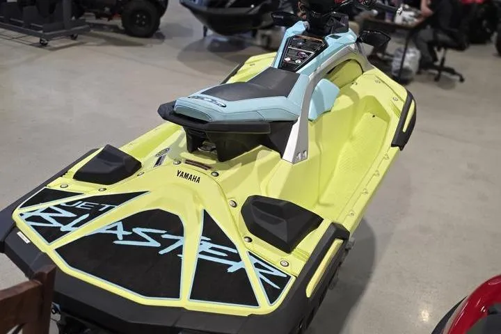 Slide: The Image of 2025 Yamaha WaveRunner JetBlaster PRO 3-Up in showroom, vibrant yellow and blue design. - 7