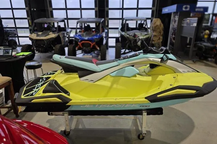 Slide: The Image of 2025 Yamaha WaveRunner JetBlaster PRO 3-Up in showroom, vibrant yellow and teal design. - 8