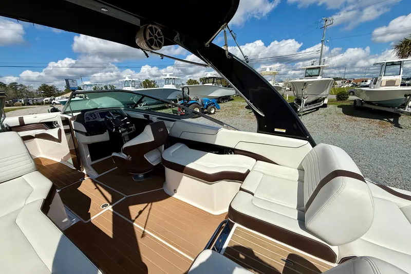 Slide: The Image of 2016 Regal 2300 Bowrider interior with luxurious seating and modern dashboard under sunny skies. - 15