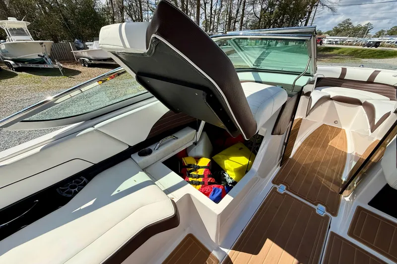 Slide: The Image of 2016 Regal 2300 Bowrider interior with open storage compartment and life jackets. - 18