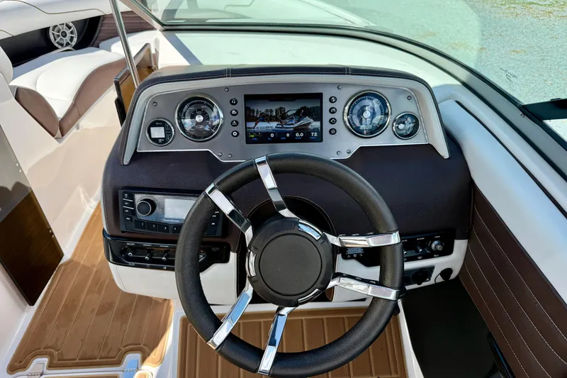 Slide: The Image of 2016 Regal 2300 Bowrider dashboard with modern controls and sleek steering wheel. - 20