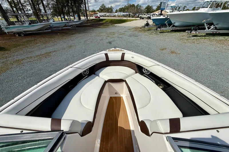 Slide: The Image of 2016 Regal 2300 Bowrider boat with spacious seating, parked outdoors. - 23