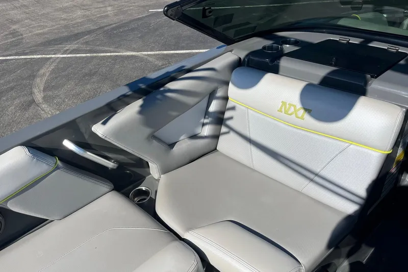 Slide: The Image of 2017 MasterCraft NXT22 boat interior with gray seating and cup holders. - 10