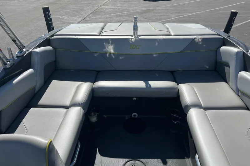 Slide: The Image of 2017 MasterCraft NXT22 boat interior with gray seating and cup holders. - 11