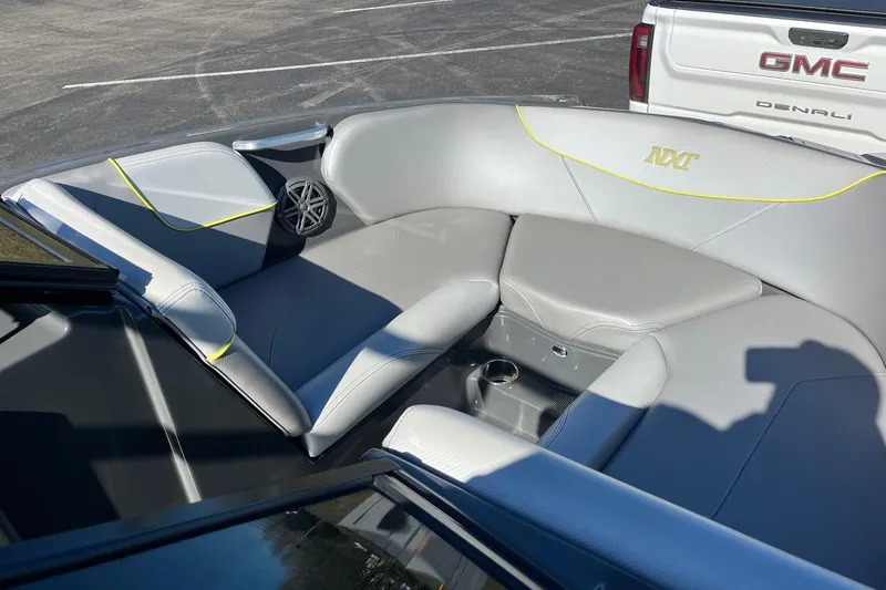Slide: The Image of 2017 MasterCraft NXT22 boat interior with gray seating and speaker detail. - 14