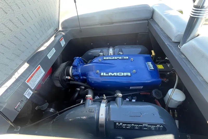 Slide: The Image of 2017 MasterCraft NXT22 engine compartment with Ilmor engine, showcasing performance components. - 16