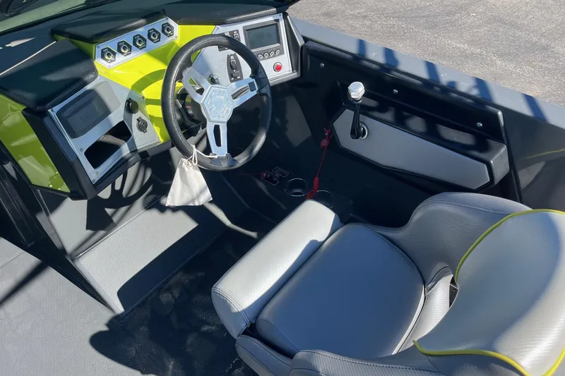 Slide: The Image of 2017 MasterCraft NXT22 boat cockpit with steering wheel and control panel. - 17