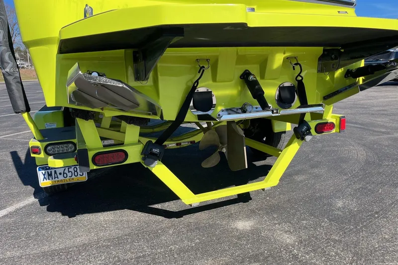 Slide: The Image of 2017 MasterCraft NXT22 boat rear view, showcasing propeller and trailer details. - 9