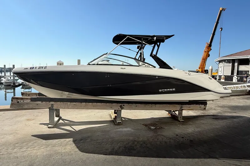 The Image of 2021 Scarab 255 ID boat on dock, black and white design, marina background. - 0
