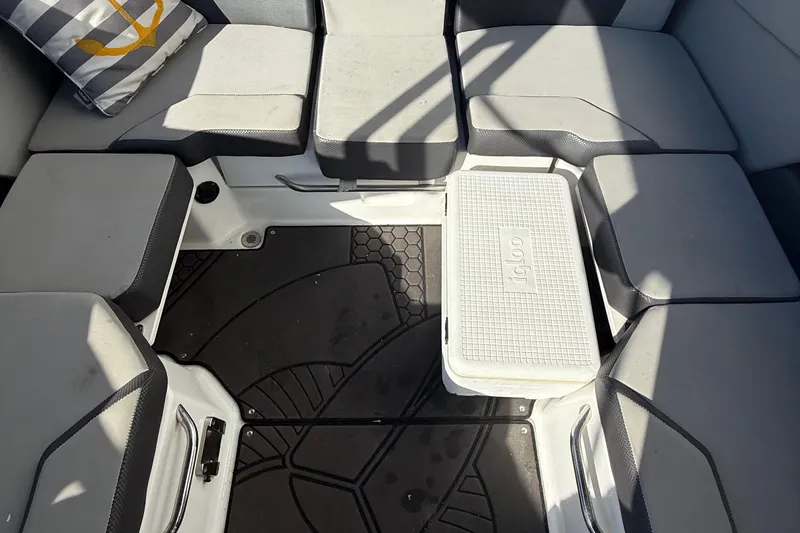 Slide: The Image of 2021 Scarab 255 ID boat interior with cushioned seating and Igloo cooler. - 12