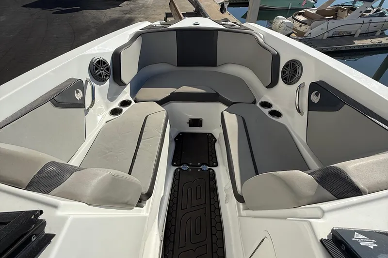 Slide: The Image of 2021 Scarab 255 ID boat interior with gray seating and cup holders. - 15