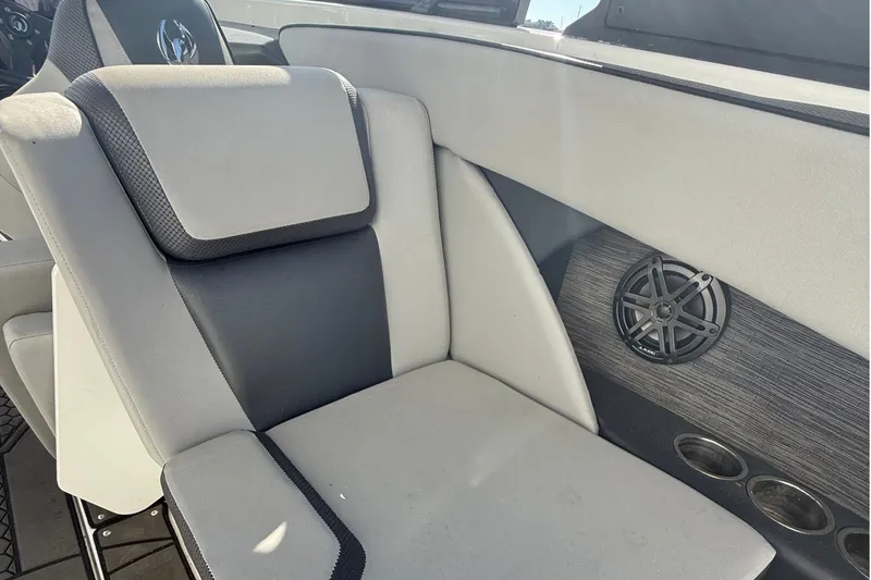 Slide: The Image of 2021 Scarab 255 ID boat interior with cushioned seating and speaker system. - 19