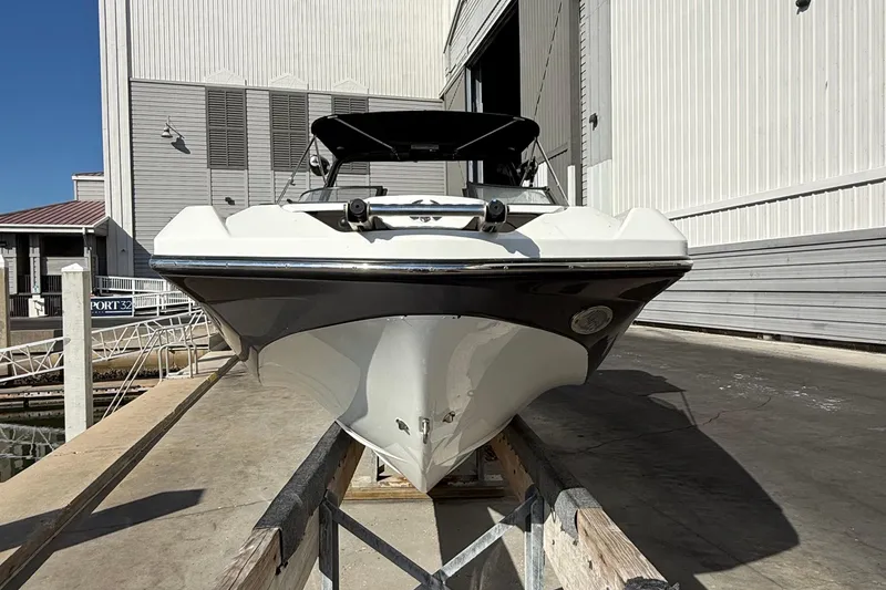 Slide: The Image of 2021 Scarab 255 ID boat docked at marina, front view. - 3
