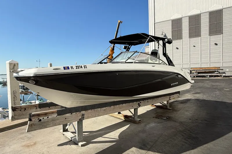 Slide: The Image of 2021 Scarab 255 ID boat on dock, black and white design, sunny day. - 4