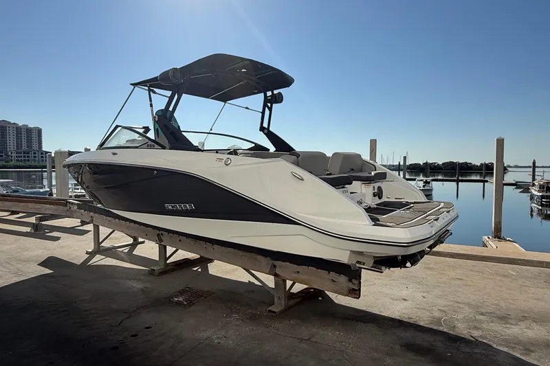 Slide: The Image of 2021 Scarab 255 ID boat docked at marina under clear blue sky. - 5