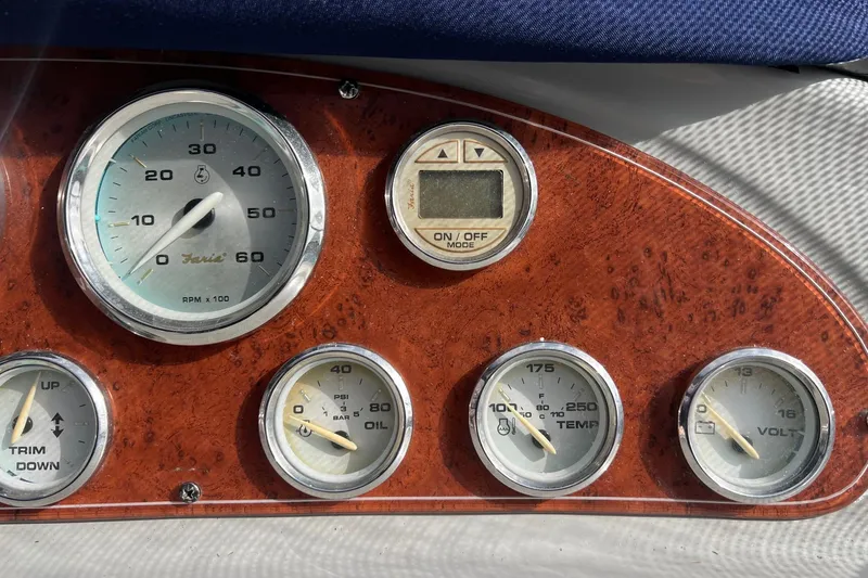Slide: The Image of Dashboard of a 2007 Bayliner 305 boat with various gauges and controls. - 10