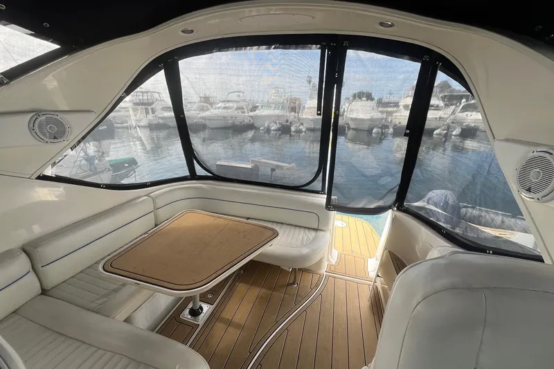 Slide: The Image of Interior of 2007 Bayliner 305 boat with seating and table, docked at marina. - 3
